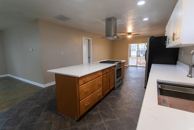 kitchen with range hood, white cabinetry, a kitchen island, sink, and stainless steel range