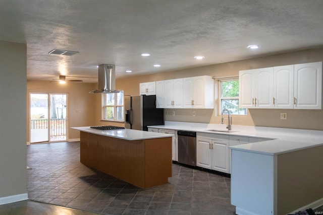 kitchen featuring white cabinetry, sink, appliances with stainless steel finishes, island range hood, and a center island