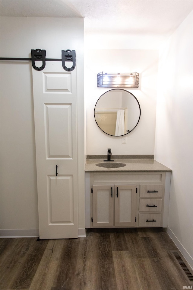 bathroom featuring vanity and hardwood / wood-style flooring