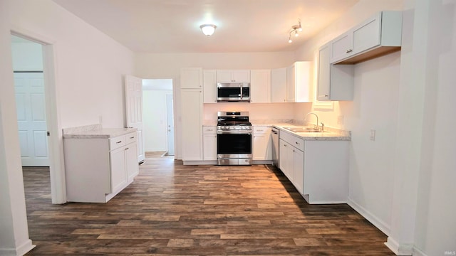 kitchen with white cabinetry, sink, dark hardwood / wood-style floors, and stainless steel appliances