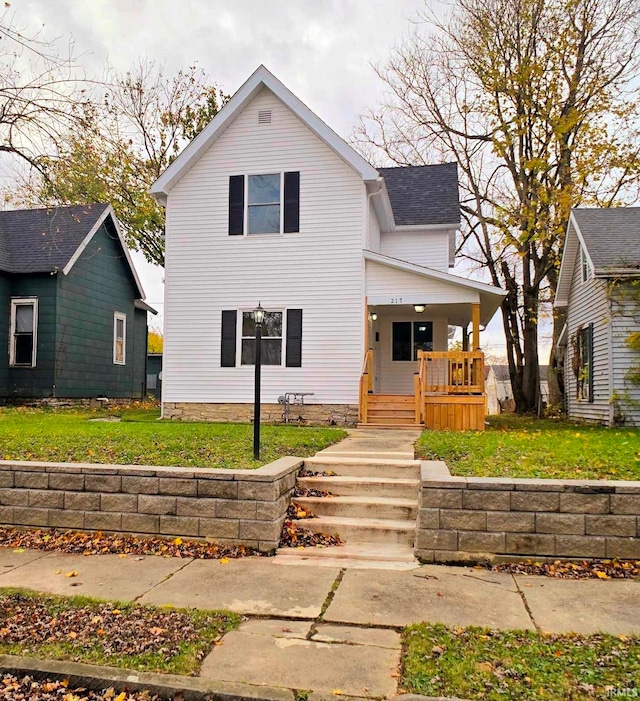 view of front facade with a front lawn and covered porch