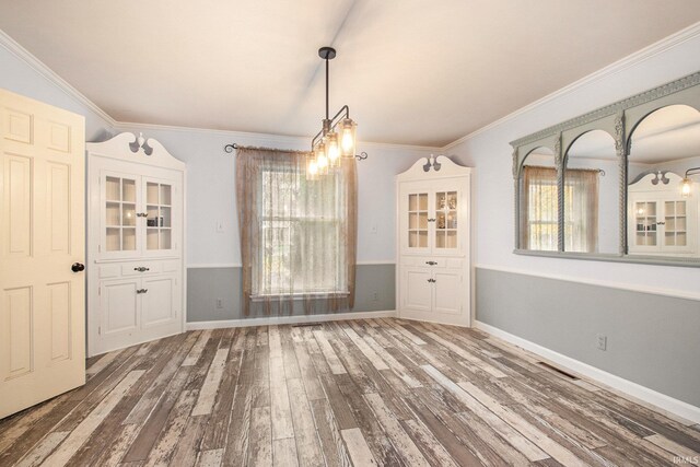 unfurnished dining area featuring hardwood / wood-style floors and crown molding