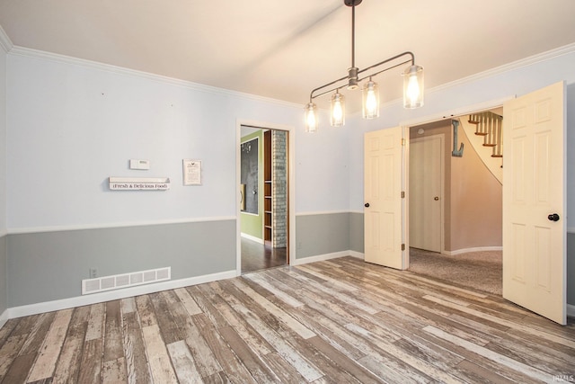 unfurnished dining area featuring wood-type flooring and crown molding