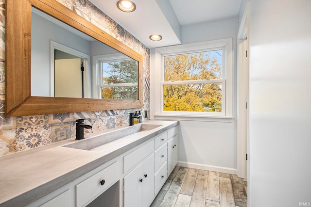 bathroom featuring vanity, decorative backsplash, and wood-type flooring