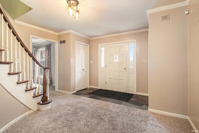 carpeted foyer featuring crown molding