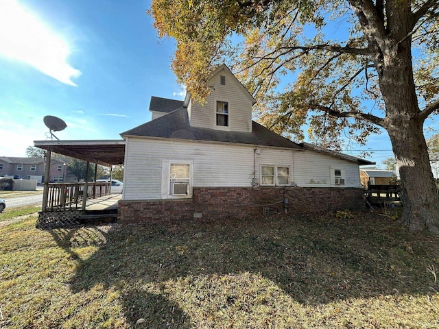 back of property with a wooden deck, cooling unit, and a lawn