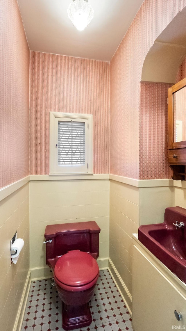 bathroom with tile walls, vanity, and toilet