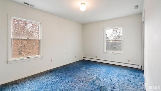 carpeted spare room with a baseboard radiator