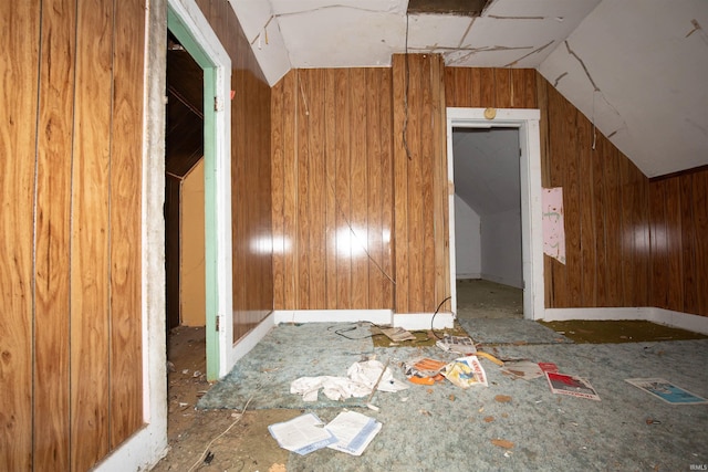 bonus room featuring wooden walls and vaulted ceiling