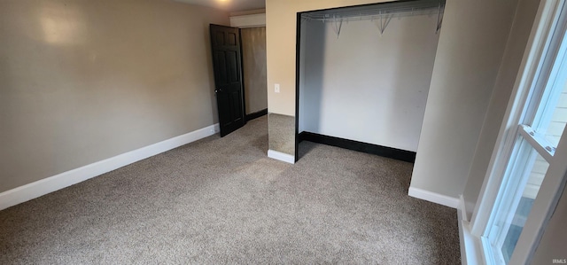 unfurnished bedroom with carpet flooring and a closet