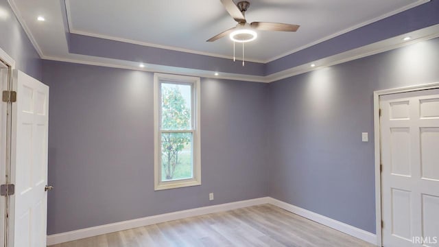 empty room with light hardwood / wood-style floors, ceiling fan, and crown molding