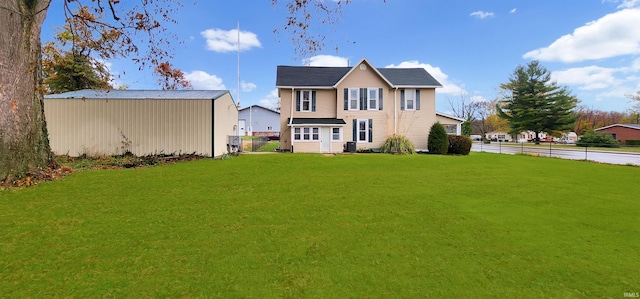 rear view of property featuring central AC unit and a yard