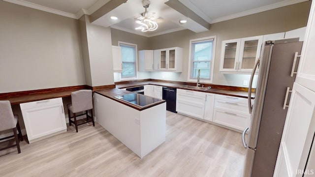 kitchen featuring black dishwasher, a wealth of natural light, sink, and stainless steel fridge