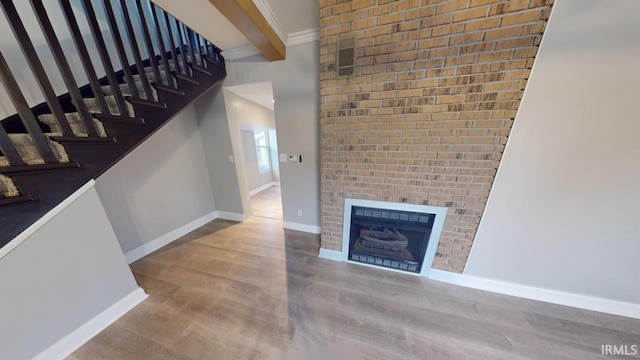 interior space with beamed ceiling, hardwood / wood-style flooring, and a fireplace