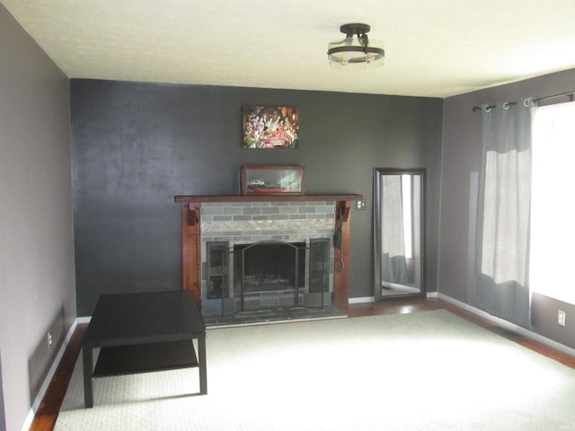 unfurnished living room featuring a brick fireplace