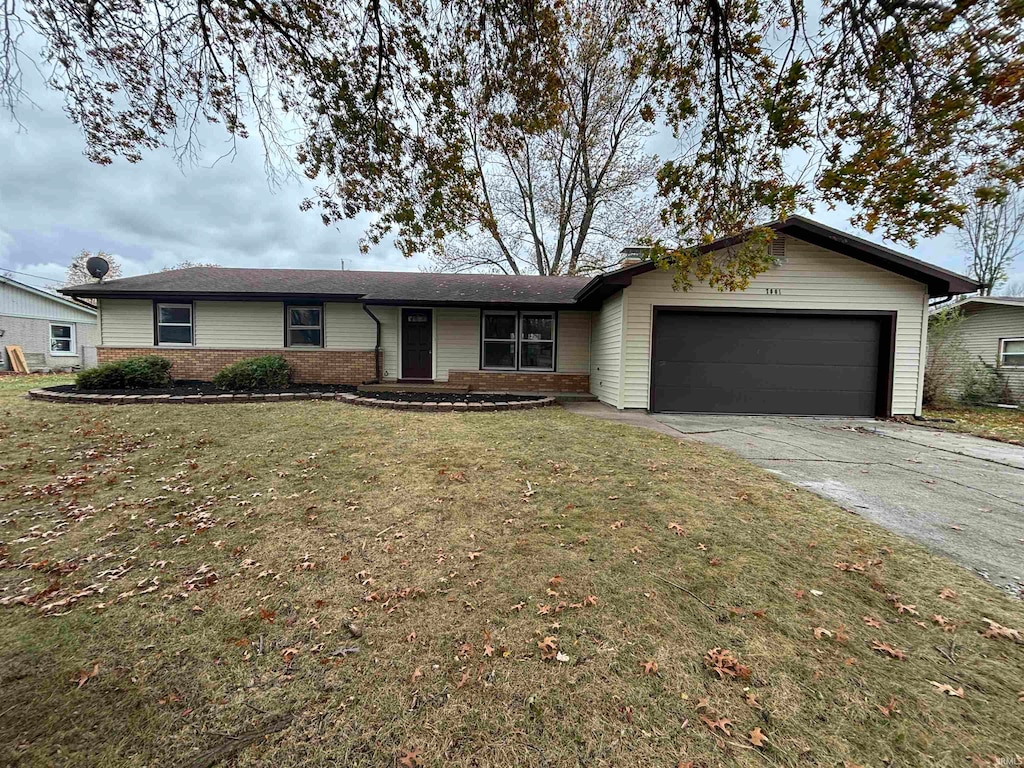 single story home featuring a garage and a front lawn