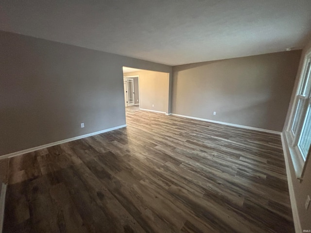 unfurnished room featuring dark hardwood / wood-style flooring