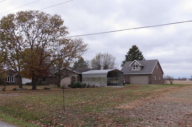 view of front of home featuring a front yard, a garage, and a carport