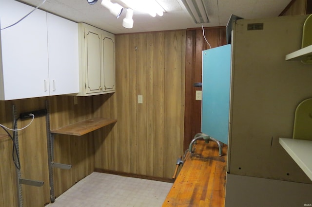 laundry area featuring wood walls