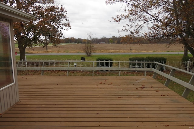 wooden deck with a rural view