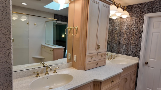 bathroom with vanity and a skylight