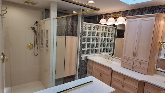 bathroom with vanity, a skylight, and walk in shower