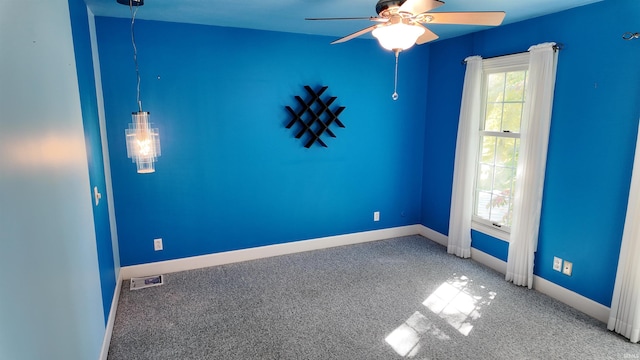 carpeted spare room with ceiling fan