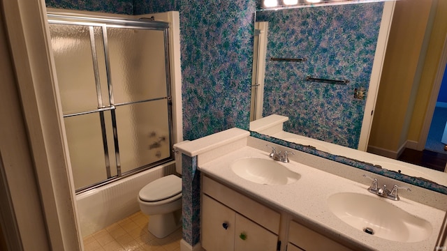 full bathroom featuring toilet, tile patterned flooring, vanity, and shower / bath combination with glass door