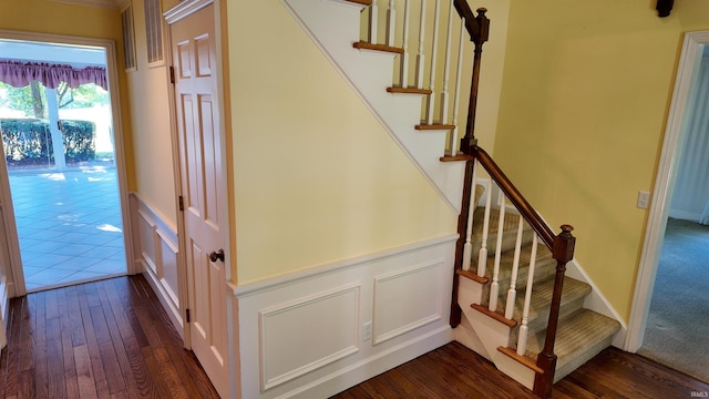 stairs featuring hardwood / wood-style floors