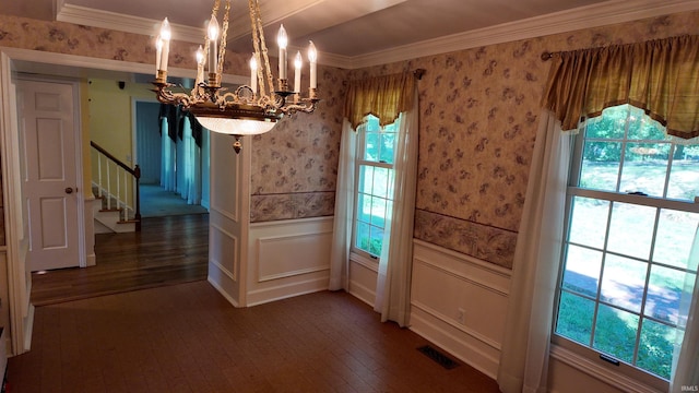 unfurnished dining area with dark hardwood / wood-style flooring, a chandelier, and ornamental molding