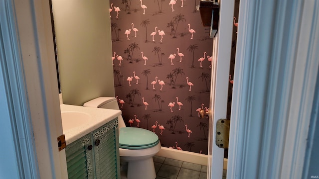 bathroom with toilet, tile patterned flooring, and vanity