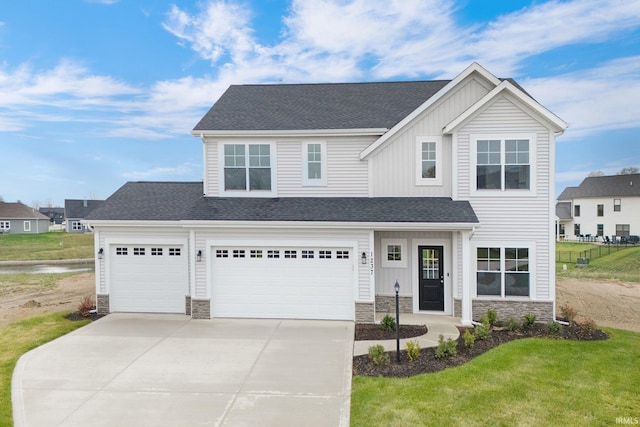 view of front of home featuring a garage and a front yard