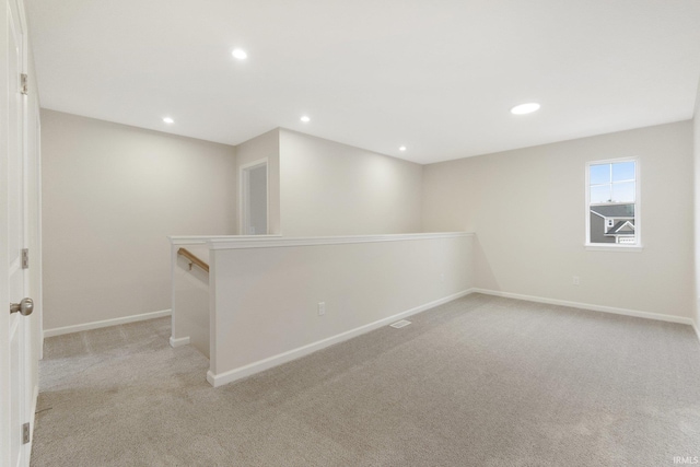 basement featuring light colored carpet