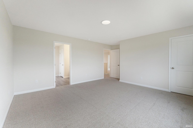 empty room featuring light carpet