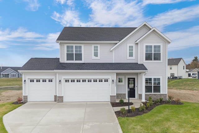 view of front of property featuring a front lawn and a garage