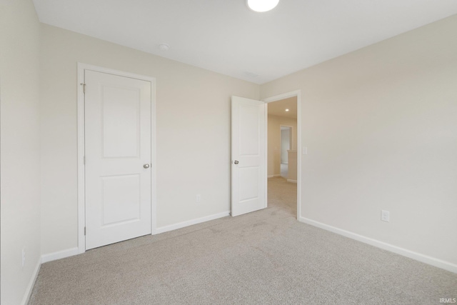 unfurnished bedroom featuring light colored carpet