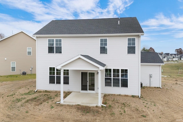 rear view of property with cooling unit and a patio