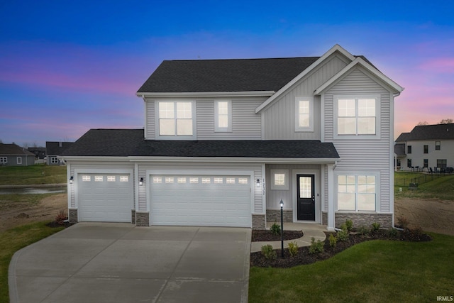 view of front facade featuring a garage and a lawn