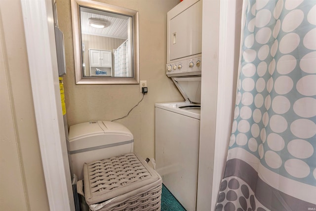 laundry room with stacked washer / dryer