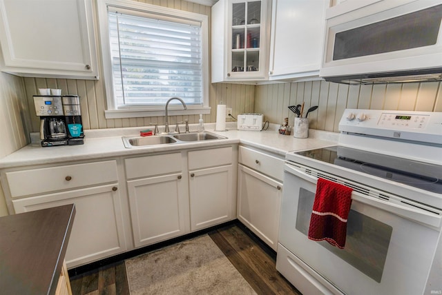 kitchen featuring dark wood-type flooring, white cabinetry, white appliances, and sink