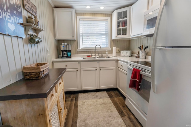 kitchen featuring white cabinets, dark wood-type flooring, sink, and white appliances