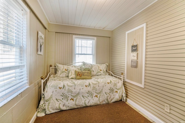 carpeted bedroom with wooden ceiling and crown molding