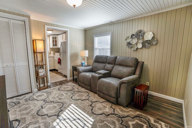 living room featuring wood walls and dark hardwood / wood-style floors