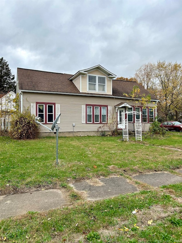 rear view of house featuring a lawn