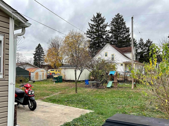 view of yard with a playground and a shed