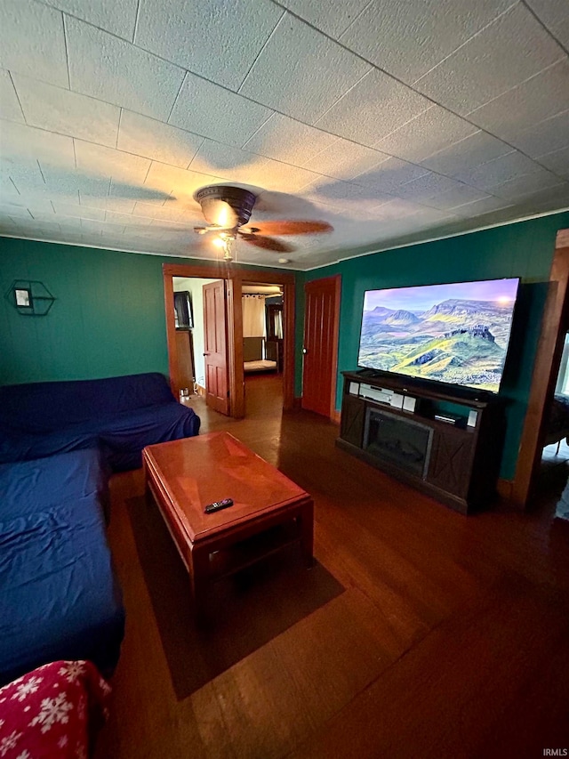 home theater featuring ceiling fan and dark hardwood / wood-style floors