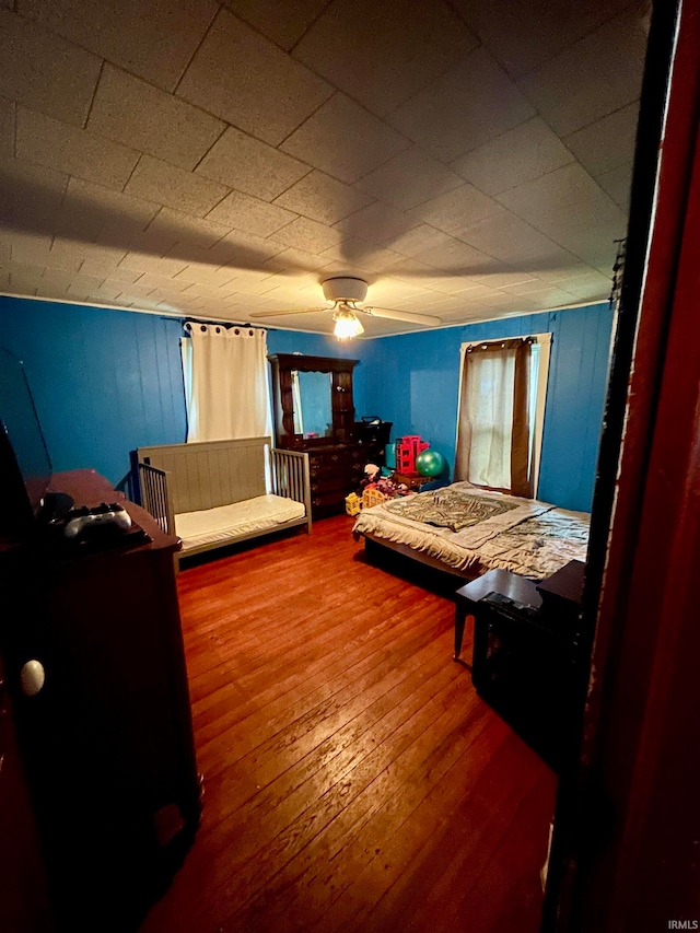 bedroom featuring hardwood / wood-style flooring and ceiling fan