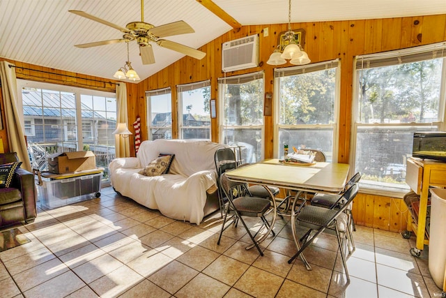 sunroom / solarium featuring a wall mounted AC, a wealth of natural light, and vaulted ceiling