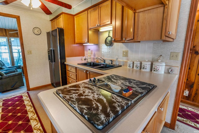 kitchen with black appliances, tasteful backsplash, sink, and ceiling fan