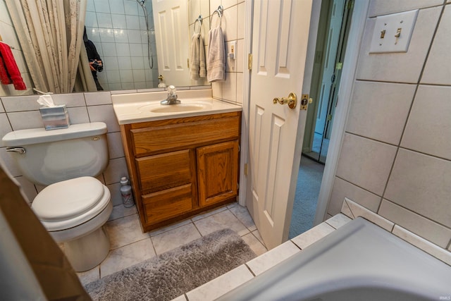 bathroom with toilet, tile walls, tile patterned flooring, decorative backsplash, and vanity